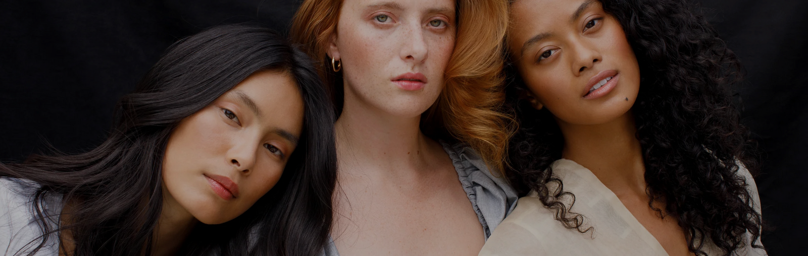 three women of different ethnicities, an asian woman, caucasian woman and black woman