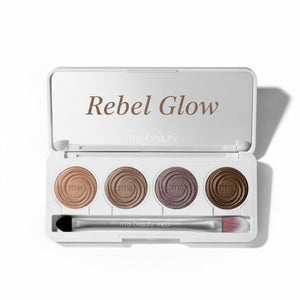 Makeup palette with four circular shades and a brush on a white background