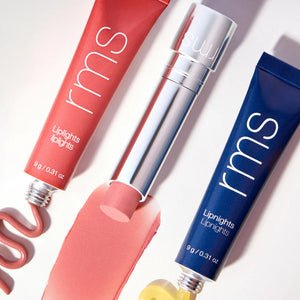 three tubes of lip products laying next to each other