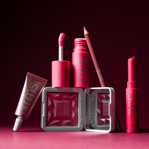 Collection of pink makeup products with 'rms' branding on a dark red background