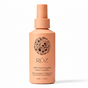 Pink bottle of ROZ Wave Texturizing Mist on a light gray background
