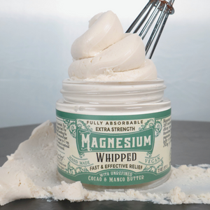 Jar of magnesium whipped cream with a whisk and whipped cream on a white background