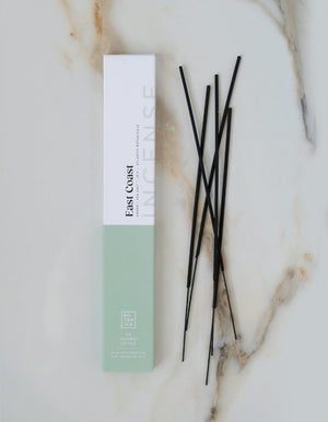 Incense sticks with packaging on a marble surface
