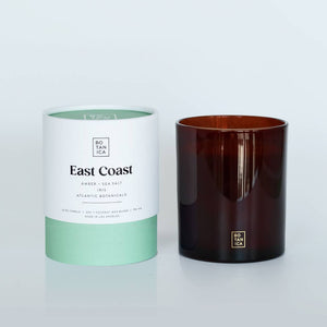 Candle and packaging labeled 'East Coast' on a light gray background