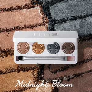 Makeup palette with four shades and a brush on a textured surface