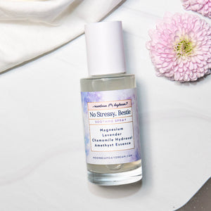 Skincare bottle labeled 'No Stressy, Bestie' with flowers on a light background