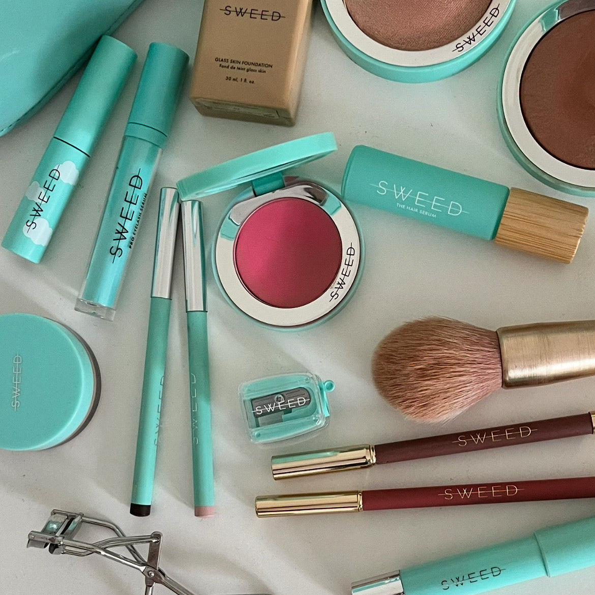 Makeup products with 'SWEED' branding on a light background