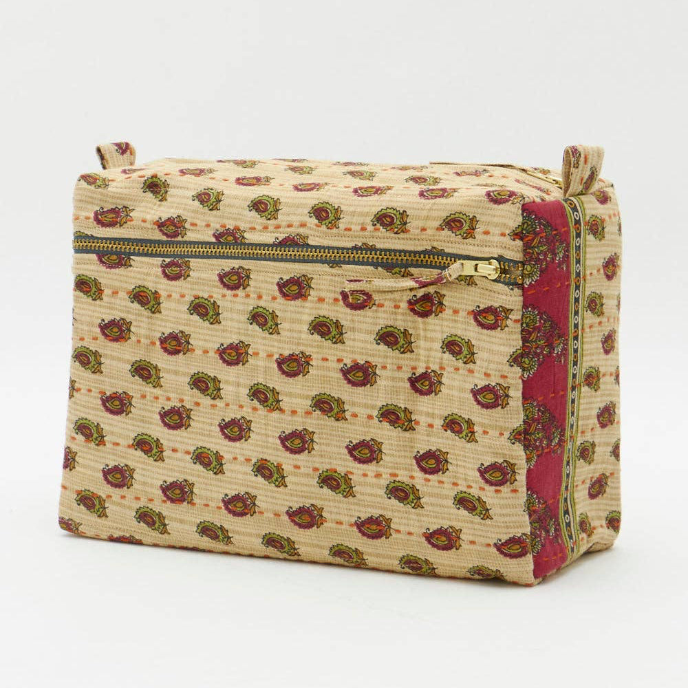 Beige toiletry bag with floral pattern and gold zipper on a white background