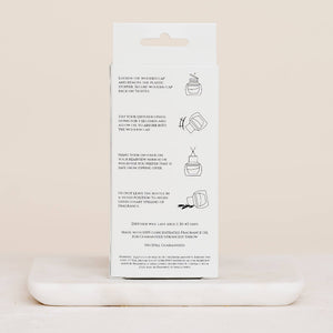 White packaging with text and icons on a beige background