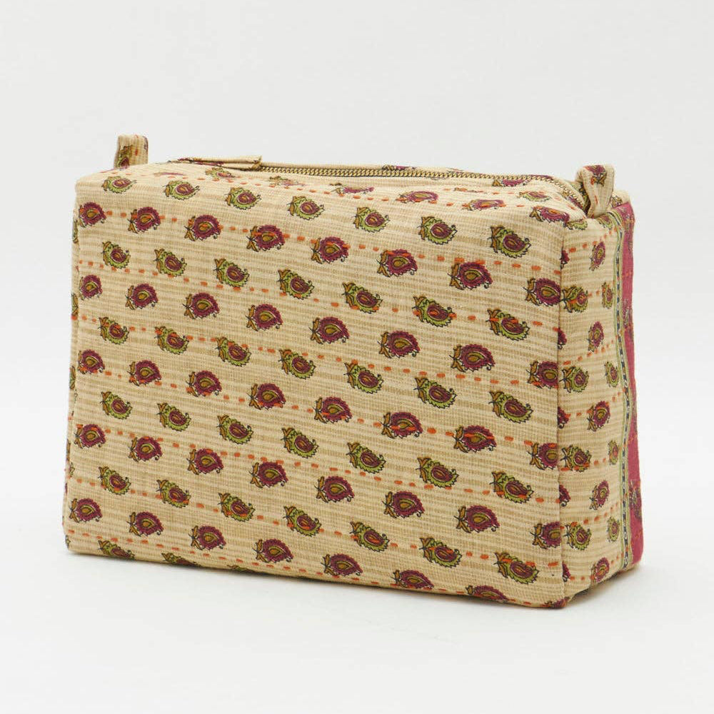 Beige toiletry bag with floral pattern and gold zipper on a white background