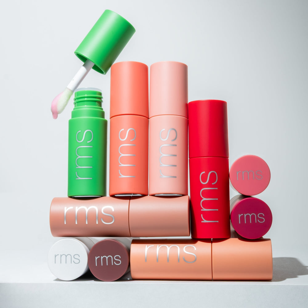 Colorful RMS beauty products on a light gray background