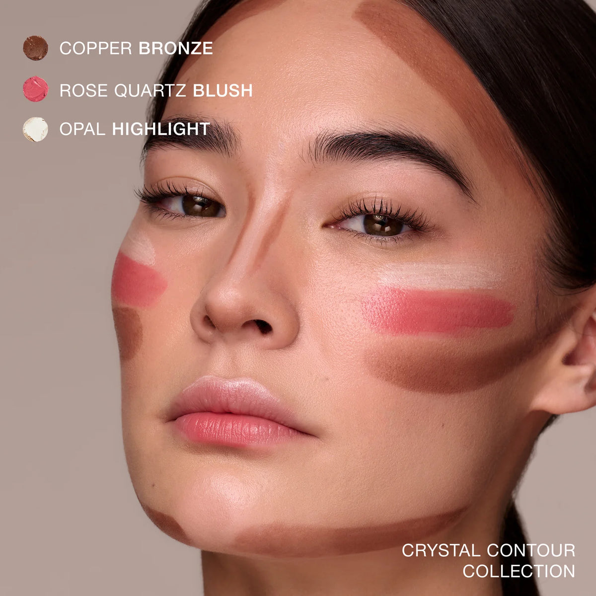 Close-up of a woman's face with makeup swatches labeled 'Copper Bronze', 'Rose Quartz Blush', and 'Opal Highlight'.