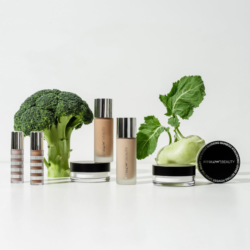 Cosmetic products with broccoli and other green vegetables on a white background