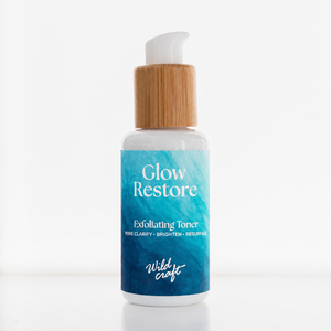 Glow Restore exfoliating toner bottle with wooden cap on a white background