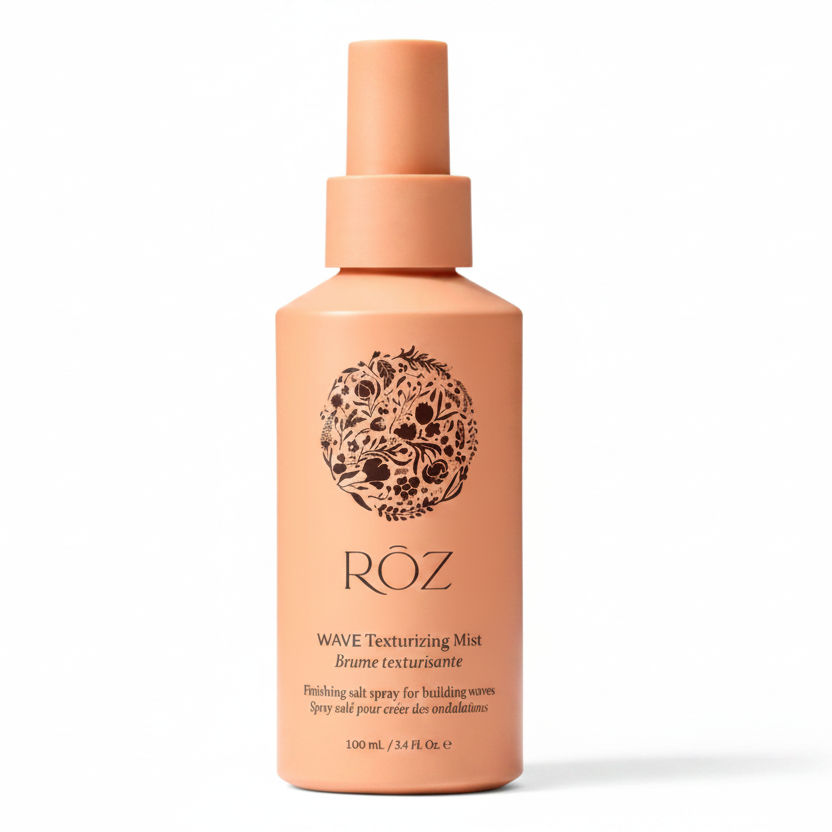 Pink bottle of ROZ Wave Texturizing Mist on a light gray background