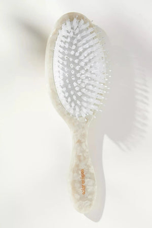 White hairbrush with bristles on a white background