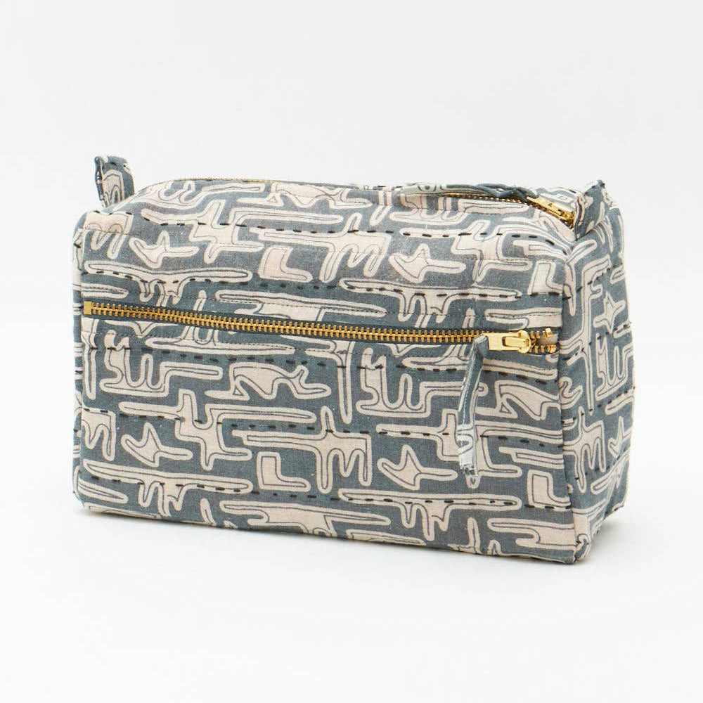 Rectangular fabric pouch with geometric pattern and gold zipper on a white background