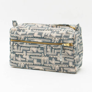 Rectangular fabric pouch with geometric pattern and gold zipper on a white background