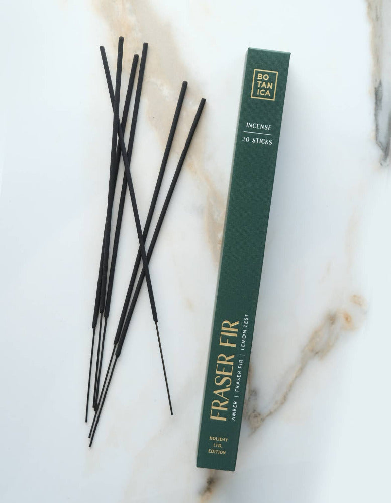 Incense sticks with a green box on a marble surface