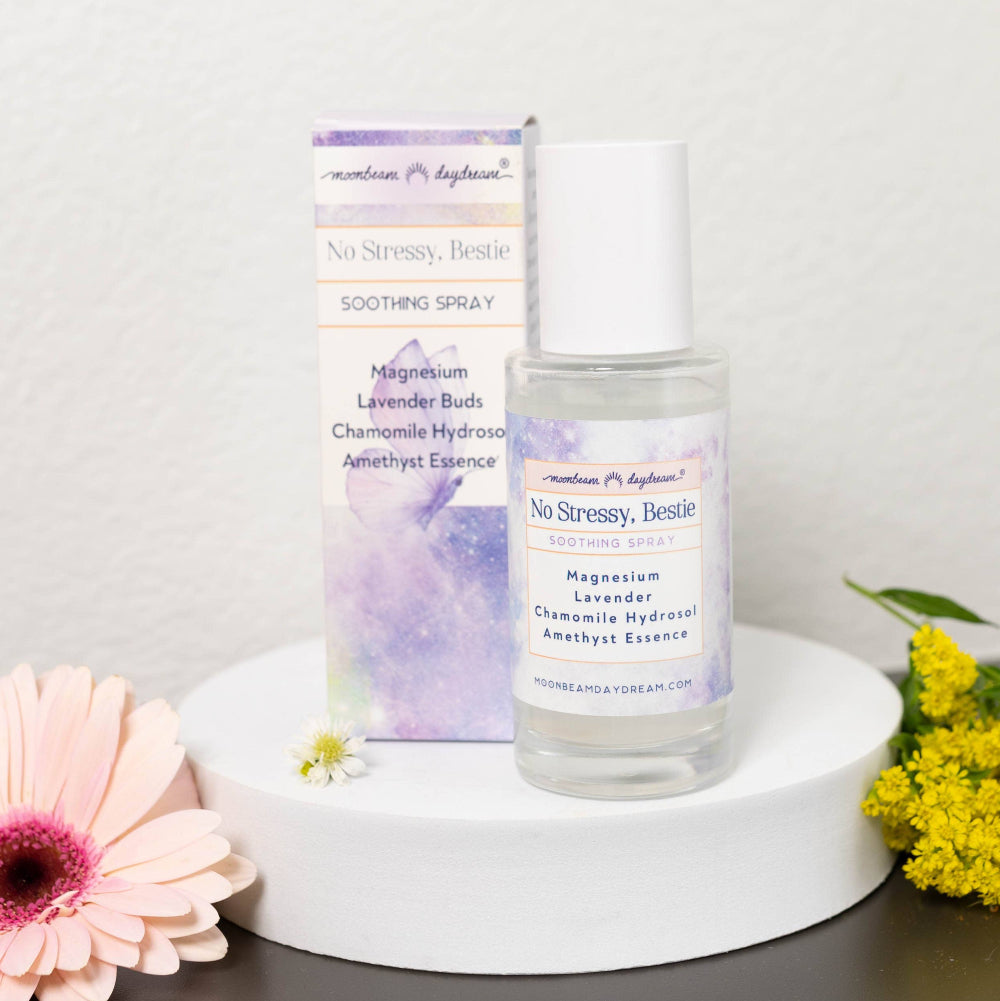 Skincare bottle labeled 'No Stressy, Bestie' with flowers on a light background